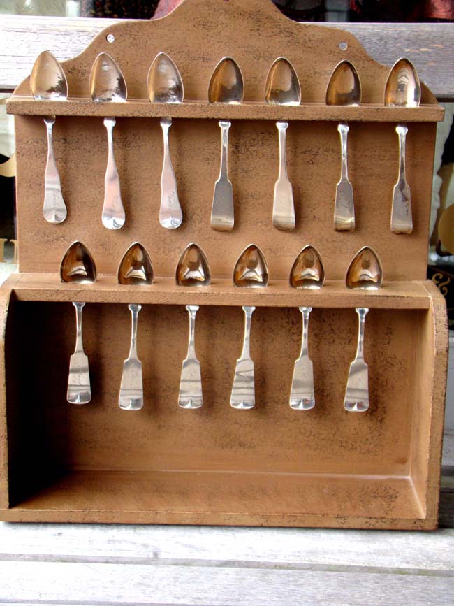 A collection of 13 American Coin Silver Teaspoons circa 1810-1840 together with a reproduction spoon rack